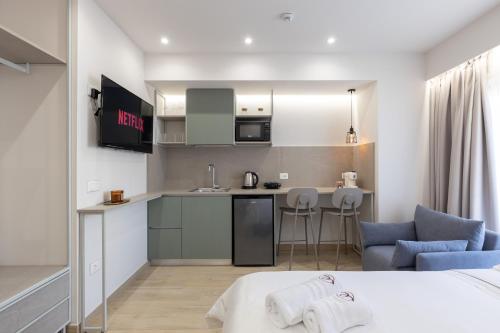 a room with a bed and a kitchen in a room at ENeR Studios in Tirana