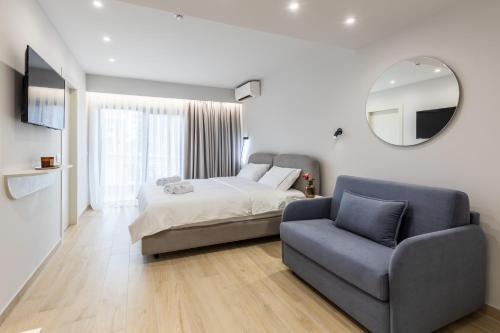 a bedroom with a bed and a chair and a mirror at ENeR Studios in Tirana