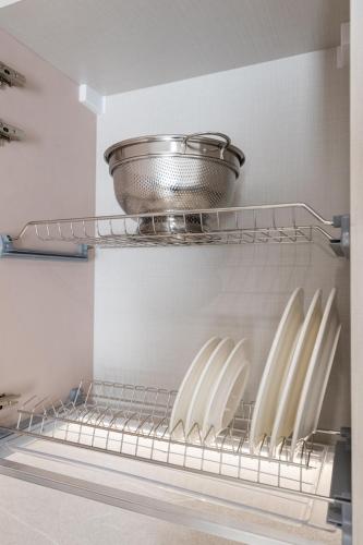 a refrigerator with a pot on top of a shelf at ENeR Studios in Tirana