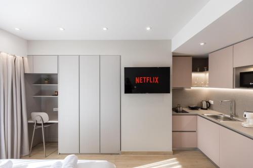a kitchen with white cabinets and a counter top at ENeR Studios in Tirana
