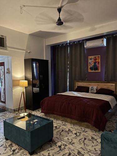 a bedroom with a bed and a coffee table at Solace Suites in Dispur