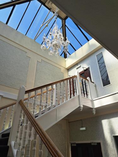 a skylight in a house with a chandelier at Scarisbrick Hotel in Southport