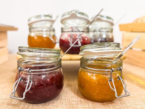 a group of jars of jam on a table at VTZ The Orus Factory Hotel - Parking Muy Económico in Zaragoza