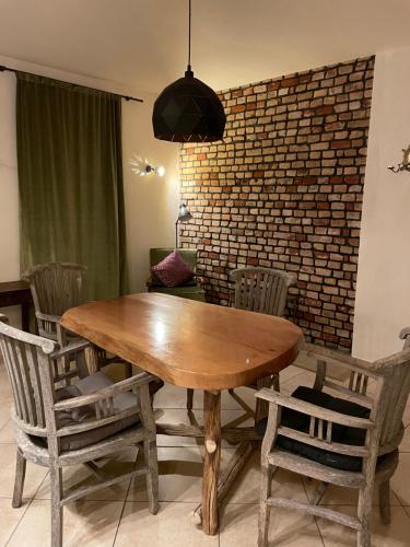 a dining room with a wooden table and chairs at Quartier im Gutshaus in Wustermark