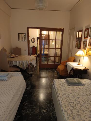 a room with two beds and a living room at CHRYSSA - ΧΡΥΣΑ in Patra