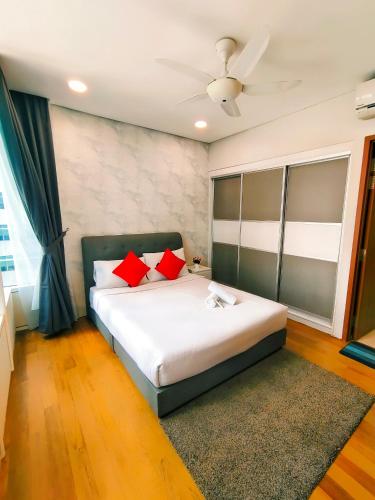 a bedroom with a large bed with red pillows at Sky Suites KLCC by KD Luxury Suites in Kuala Lumpur