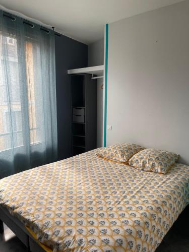 a bedroom with a bed with two pillows on it at Rooftop d'exception au Cœur du Puy-en-Velay in Le Puy en Velay