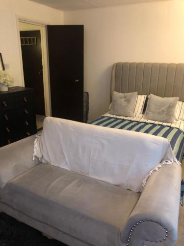 a bed and a couch in a bedroom at Nw2 Studio Flat mins to London in London