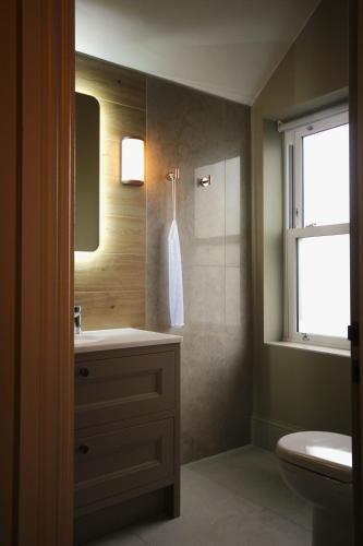 a bathroom with a sink and a window at Coach & Horses Dersingham in Dersingham