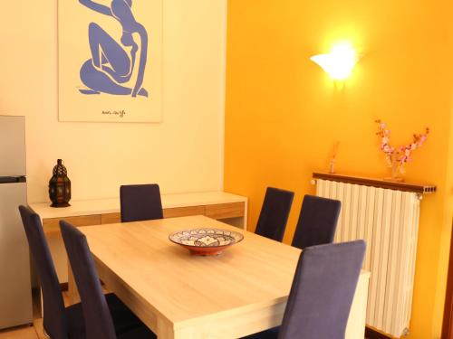 a dining room with a wooden table and chairs at Villa Turchese - private pool & jacuzzi in Sulzano