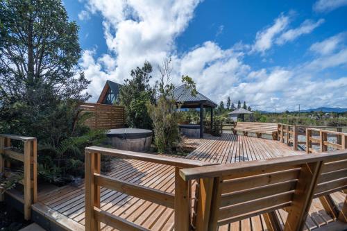 a wooden deck with a gazebo at Parque la Pajarera in Puerto Varas