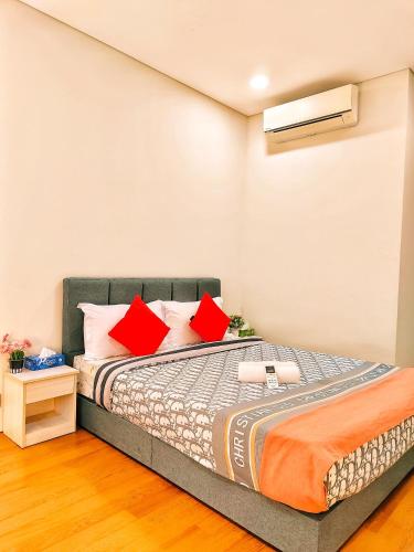 a bedroom with a bed with red pillows at Sky Suites KLCC by KD Luxury Suites in Kuala Lumpur