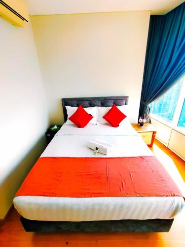 a bedroom with a large bed with red pillows at Sky Suites KLCC by KD Luxury Suites in Kuala Lumpur