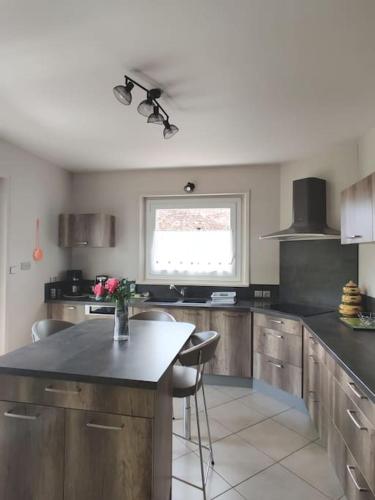 a kitchen with a counter and a window in it at Maison à louer à Allègre in Allègre