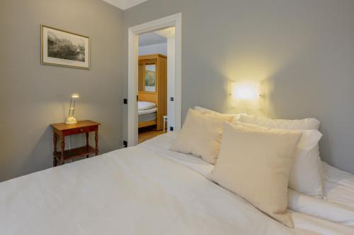 a white bed with white pillows in a bedroom at Apartment in Södermalm 1-4 people 47 sqm in Stockholm