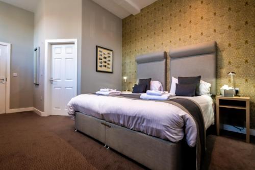 a bedroom with a large bed in a room at The Lamplighter Dining ~ Rooms in Windermere