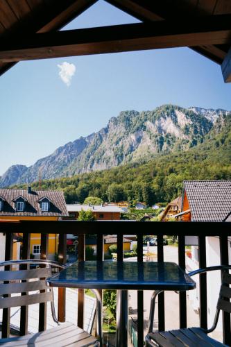a table on a balcony with a view of a mountain at Mountain View Salzburg - SELF CHECK-IN - Apartments in Grödig