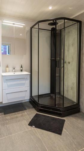a bathroom with a glass shower and a sink at Malangen Lodge in Tromsø