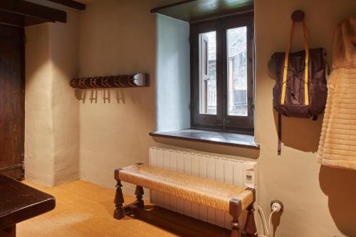 a room with a bench and a window at Pleta Baqueira Luxe 3 by FeelFree Rentals in Naut Aran