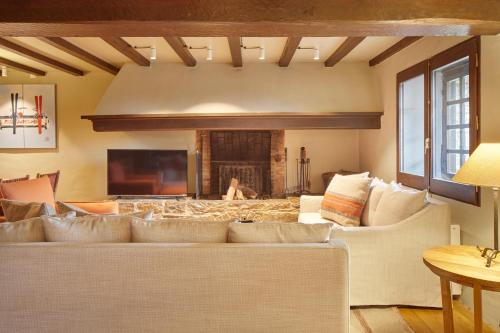 a living room with a couch and a fireplace at Pleta Baqueira Luxe 3 by FeelFree Rentals in Naut Aran