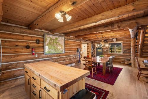a dining room and kitchen in a log cabin at UC River Ranch in Emigrant