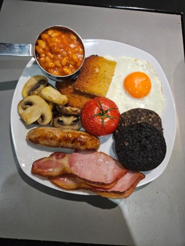 a plate of breakfast food with eggs sausage meat and beans at Craggan in Ballater
