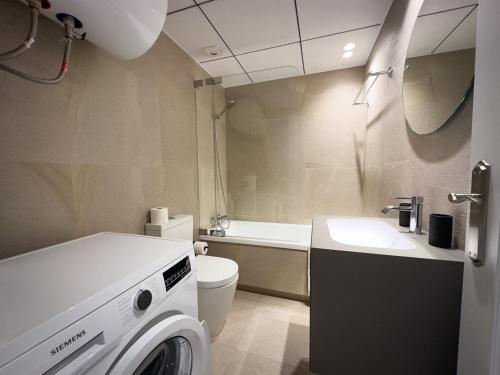 a bathroom with a washing machine and a sink at Beachfront Apartment Primera Línea 2-04 in Orihuela Costa