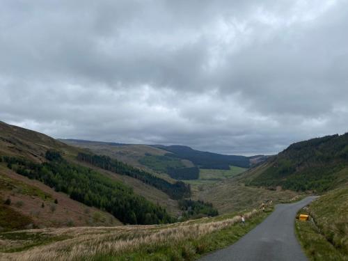 a winding road through the hills in the uk at Pen y Cwm in Penmachno