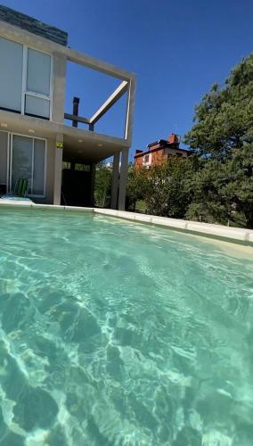 a swimming pool in front of a house at Casa Cabalango in Cavalango