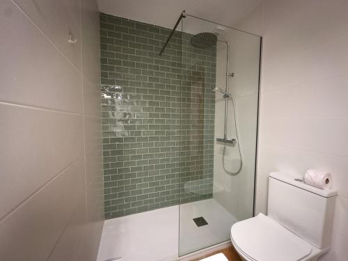 a bathroom with a toilet and a glass shower at Beachfront Apartment Primera Línea 2-06 in Orihuela