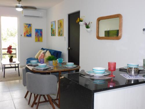 a kitchen with a table and a dining room at CARRIBEAN DELUXE Apartment in Playa del Carmen