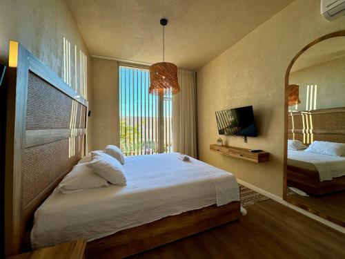 a bedroom with a large bed and a mirror at Aquaterra, Green Coast in Palasë
