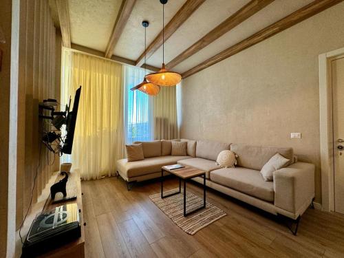 a living room with a couch and a table at Aquaterra, Green Coast in Palasë