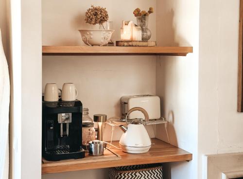 a shelf with a coffee maker and appliances on it at Quinta Amarela - B&B in Nazaré