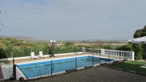 a swimming pool with a fence around it at Villa Alare in Almodóvar del Río