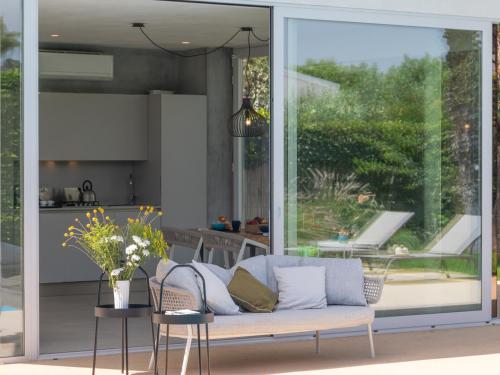 a living room with a couch and a kitchen at VILLA MANDORLO 4, Emma Villas in Ragusa