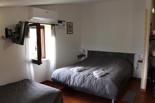 a bedroom with a bed with two towels on it at Casa Trevisan in Marco Simone