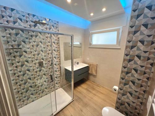a bathroom with a shower and a sink at Anna Luxury Apartment in Bisceglie