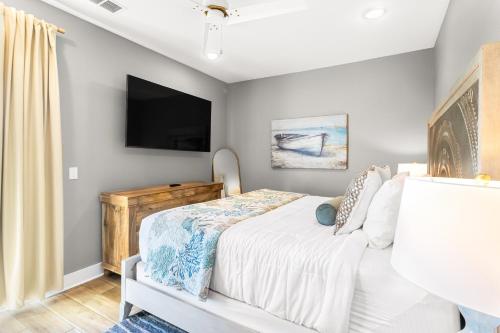a bedroom with a bed and a flat screen tv at Port Paradise in Highland View