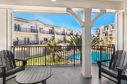 a balcony with chairs and a view of a building at Port Paradise in Highland View