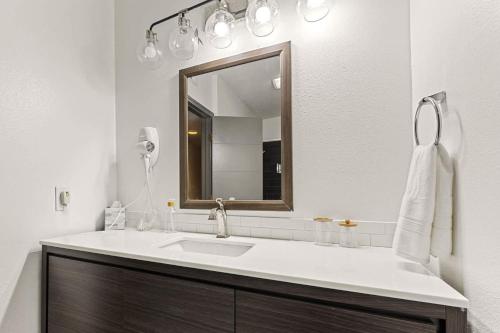 a bathroom with a sink and a mirror at Newly Renovated 6BR 3BA Port Arthur Holiday Home with Hot Tub in Port Arthur