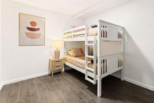 a bedroom with two bunk beds and a lamp at Newly Renovated 6BR 3BA Port Arthur Holiday Home with Hot Tub in Port Arthur