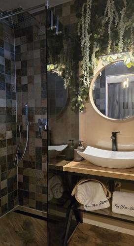 a bathroom with a sink and a mirror at For You Apartments Silence in Sibiu