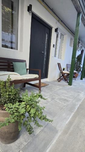 a porch with a bench in front of a door at For You Apartments Silence in Sibiu