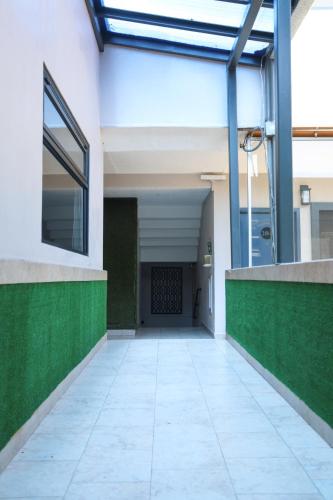 an empty hallway of a building with green plants at Hotel Aqua Rio in Tijuana