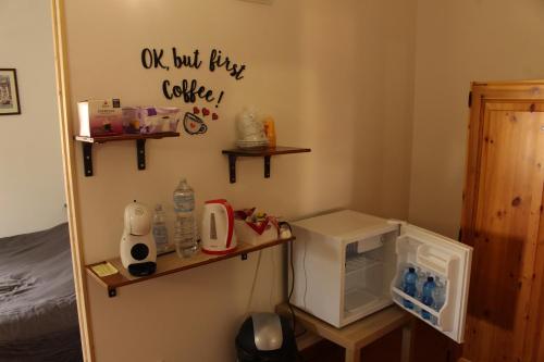 a kitchen with a small refrigerator and a sign on the wall at Casa Trevisan in Marco Simone
