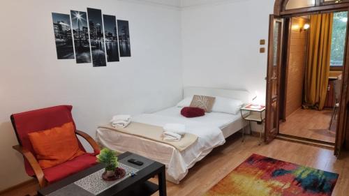 a small room with a bed and a chair at Feeria National Parc in Bucharest