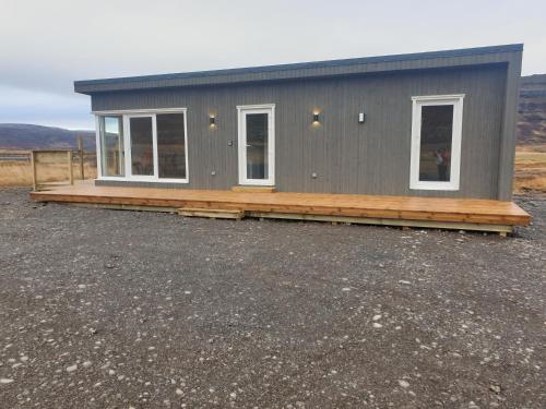 a tiny house sitting on top of a lot at Hvammur 9 with private hot tub in Drangsnes