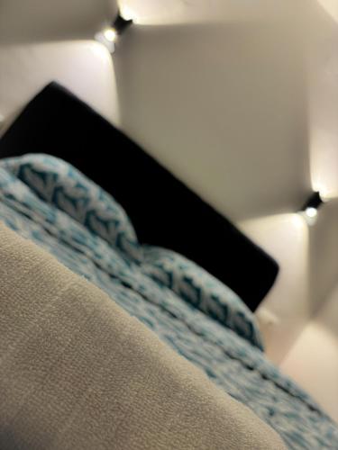 a close up of a bed with a pillow on it at Apartman Lamela in Zenica
