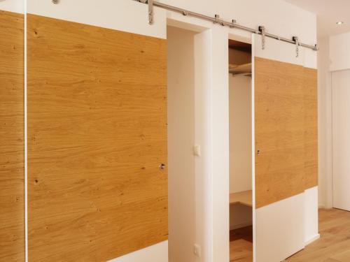 a room with a closet with wood paneling at Brunnwirt ESSEN & WOHNEN in Fuschl am See